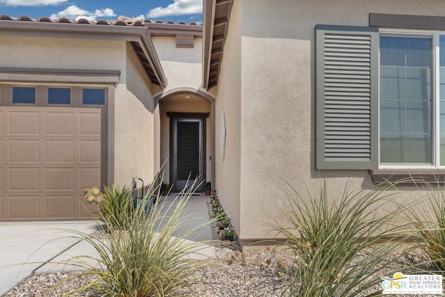 view of exterior entry featuring a garage