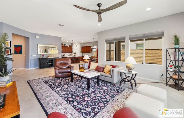 tiled living room featuring ceiling fan