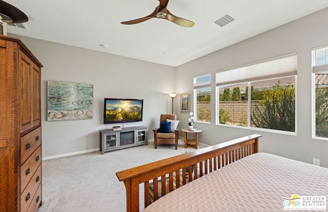 carpeted bedroom with multiple windows and ceiling fan