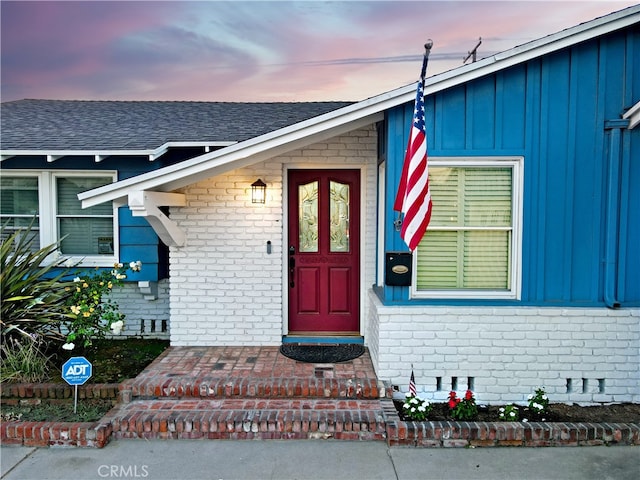 view of exterior entry at dusk