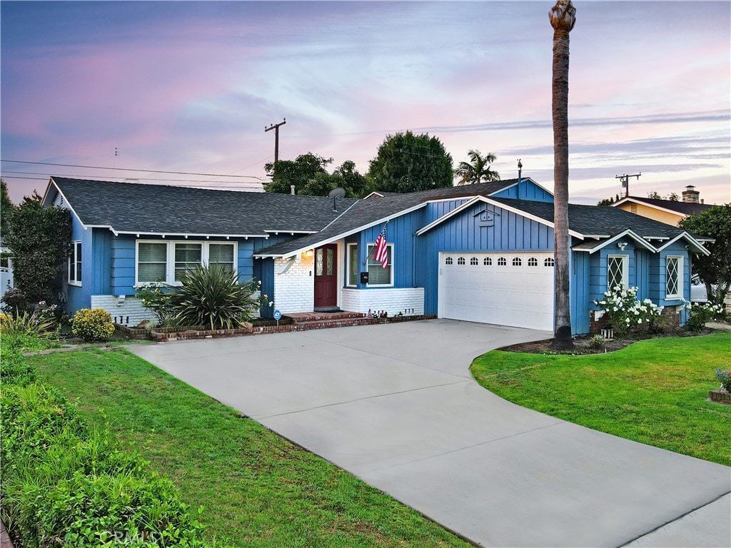 ranch-style house with a lawn and a garage