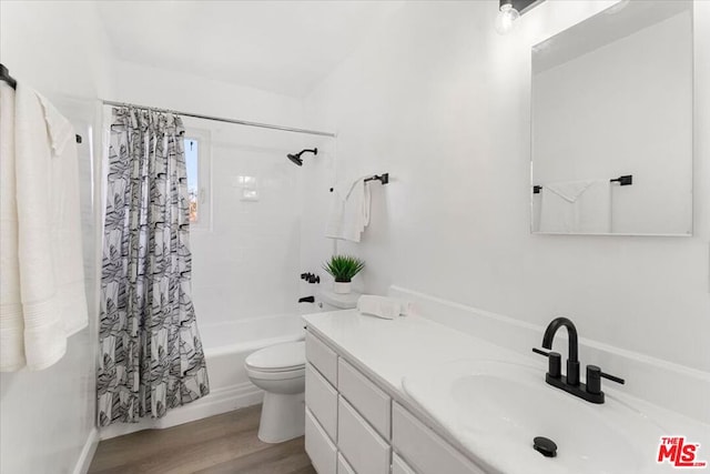 full bathroom featuring wood-type flooring, toilet, vanity, and shower / tub combo with curtain