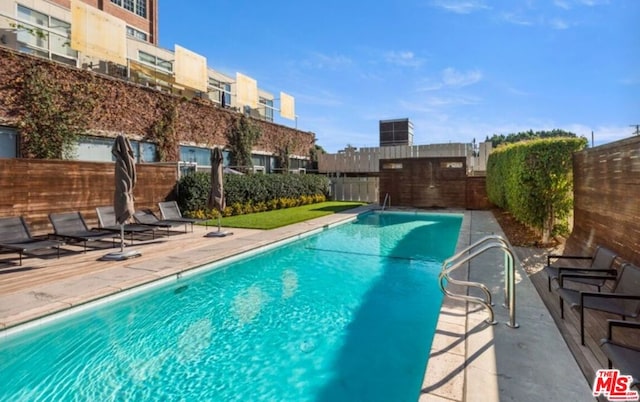 view of swimming pool featuring a patio area