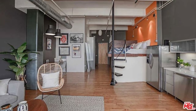 kitchen featuring stainless steel appliances and light hardwood / wood-style floors