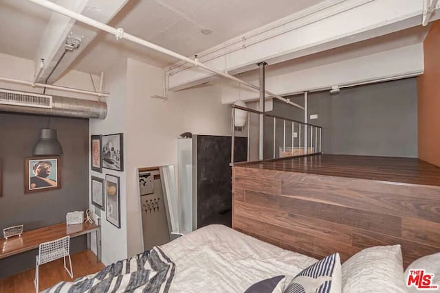 bedroom with dark hardwood / wood-style floors