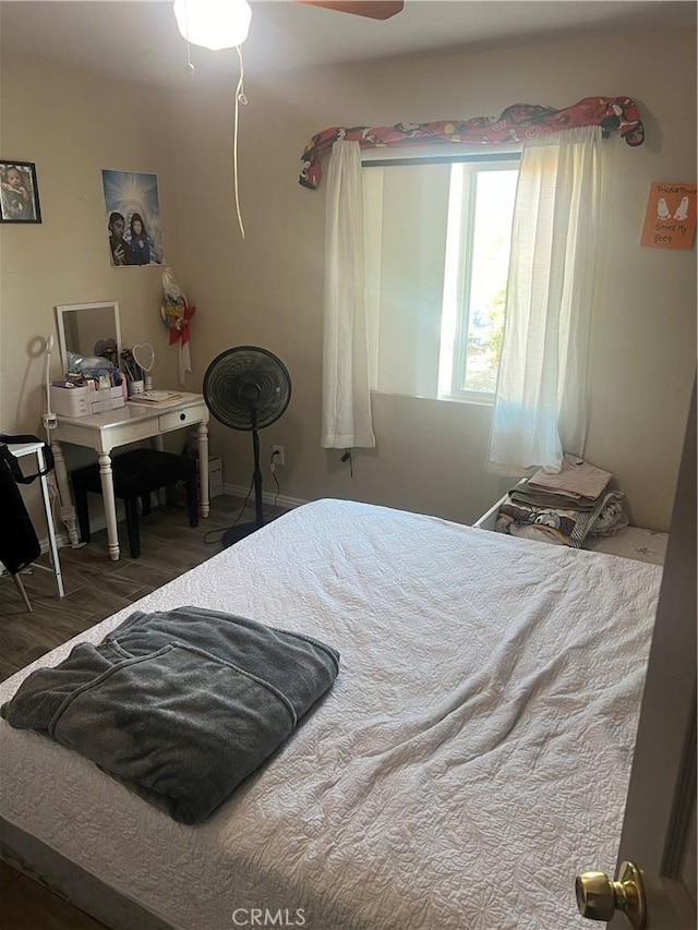 bedroom featuring ceiling fan and dark wood-type flooring