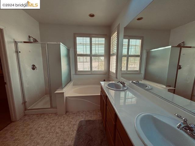 bathroom featuring tile patterned flooring, separate shower and tub, and vanity