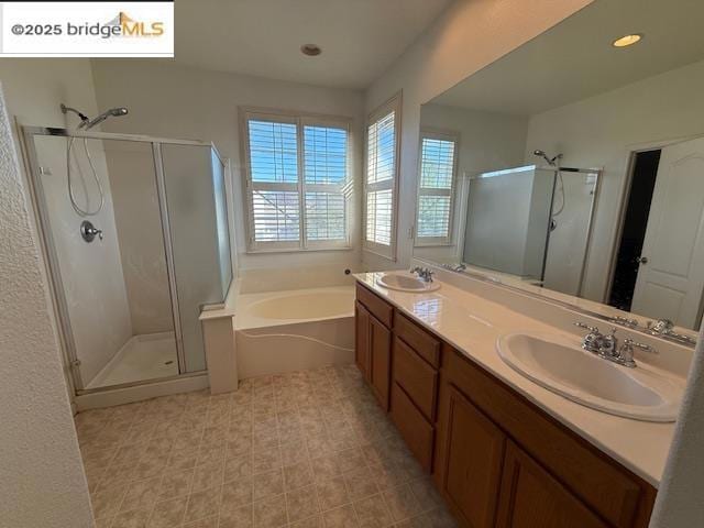 bathroom featuring separate shower and tub and vanity