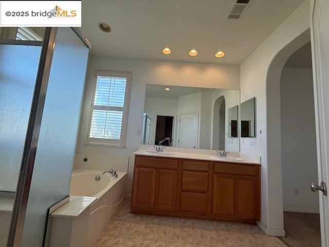 bathroom with vanity and a bathing tub