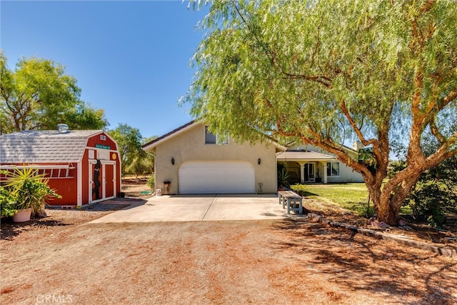 view of front of house featuring a shed, a garage, and a front yard