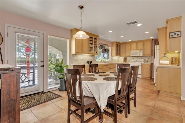 tiled dining area featuring plenty of natural light