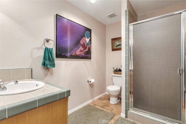 bathroom featuring vanity, toilet, tile patterned floors, and an enclosed shower