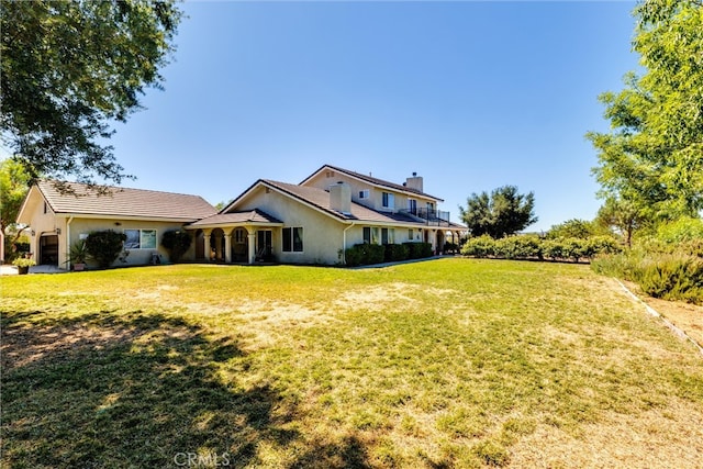 rear view of property with a lawn