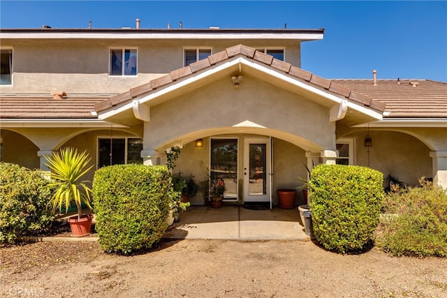 property entrance with french doors and a patio area