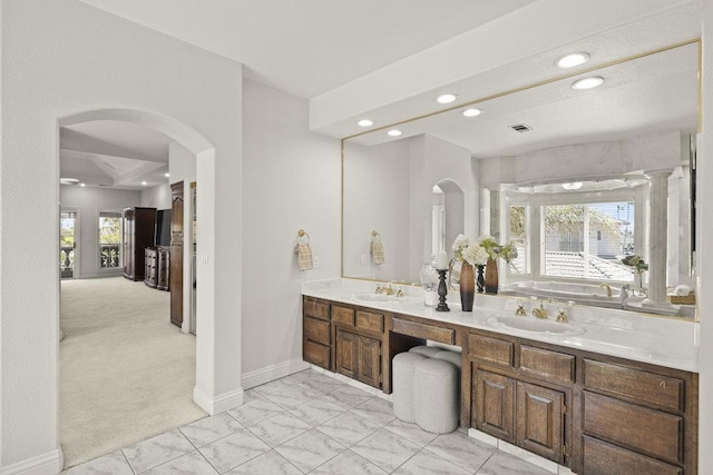 bathroom featuring vanity, ornate columns, and plenty of natural light