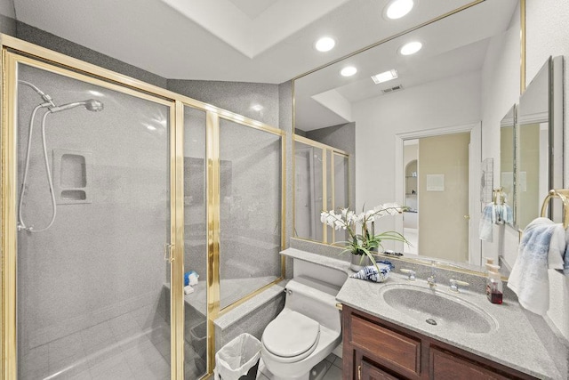 bathroom featuring vanity, toilet, and walk in shower