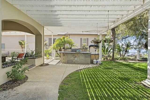 view of patio / terrace featuring exterior kitchen, an outdoor bar, and a pergola