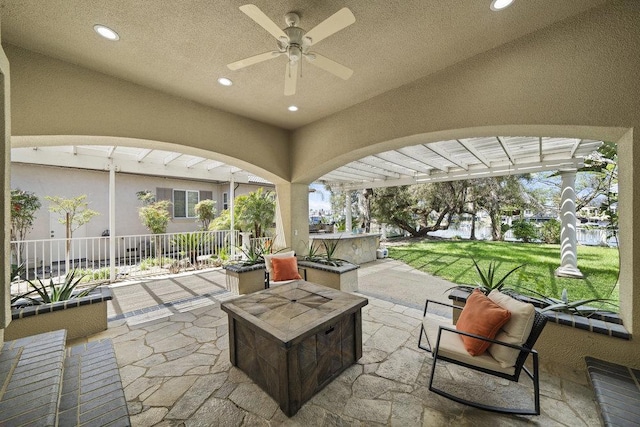 view of patio / terrace with area for grilling, a fire pit, and ceiling fan