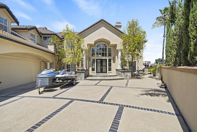 exterior space with french doors and a garage