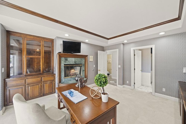 office featuring light carpet, a high end fireplace, a raised ceiling, and ornamental molding