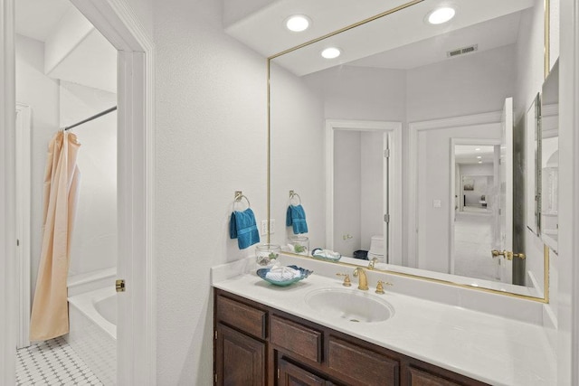 full bathroom with vanity, shower / bath combo with shower curtain, toilet, and tile patterned flooring