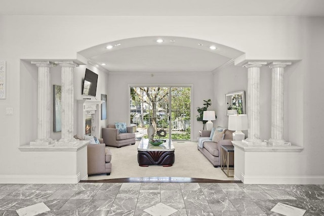 living room featuring crown molding and decorative columns