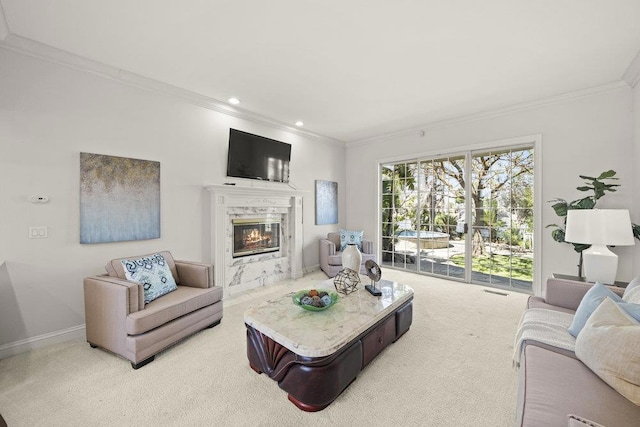 carpeted living room featuring crown molding and a high end fireplace