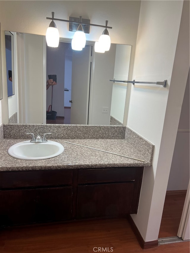 bathroom with vanity and hardwood / wood-style flooring