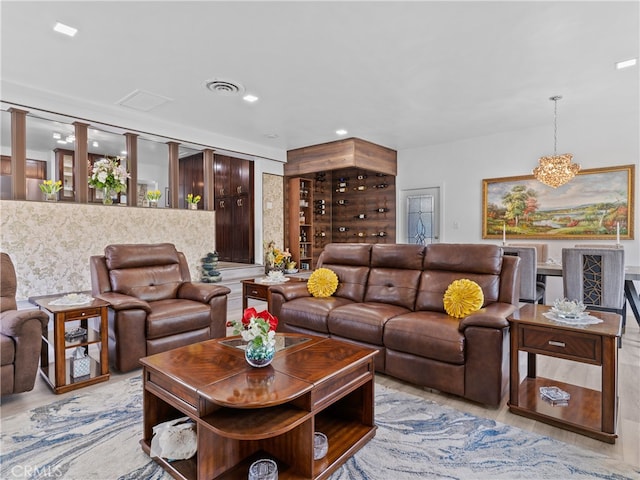 living room with light hardwood / wood-style flooring and a notable chandelier