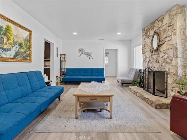 living room featuring light hardwood / wood-style flooring and a fireplace