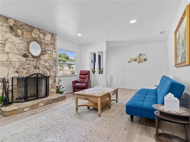 living room with hardwood / wood-style flooring and a fireplace