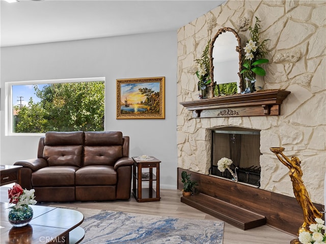 living room featuring light hardwood / wood-style flooring and a fireplace