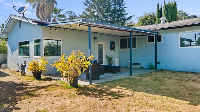 rear view of property with a patio area and a lawn