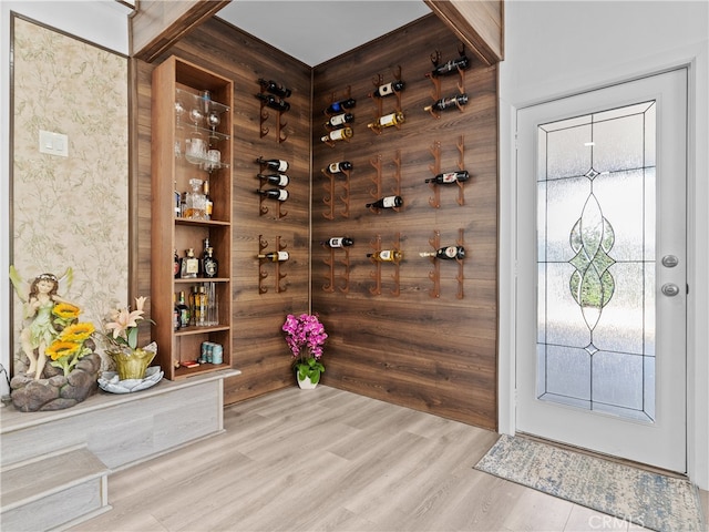 wine area with light hardwood / wood-style floors and plenty of natural light