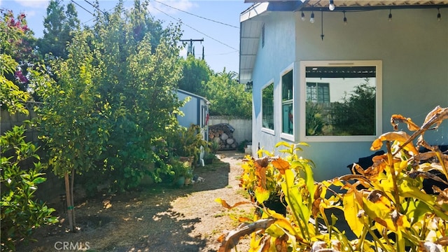 view of side of home featuring a storage unit