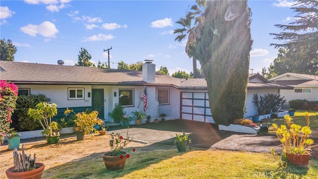 ranch-style home featuring a front yard and a garage