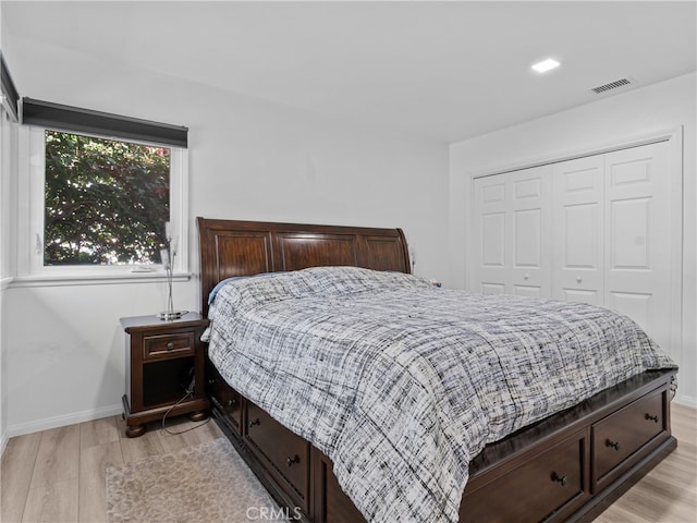 bedroom featuring a closet and light hardwood / wood-style flooring