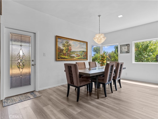 dining space with an inviting chandelier and light wood-type flooring