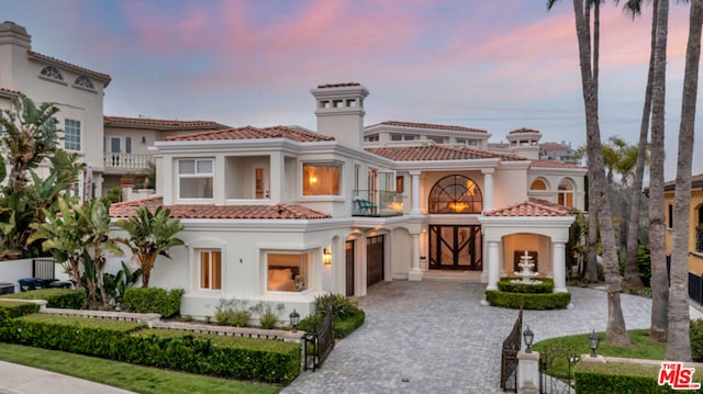 mediterranean / spanish-style home featuring a balcony