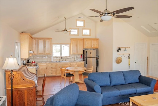 living room with high vaulted ceiling, sink, and light tile patterned floors