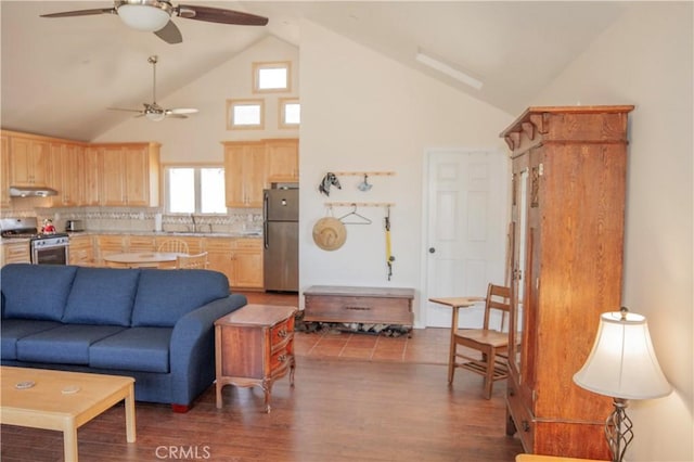 living room featuring sink, dark wood-type flooring, high vaulted ceiling, and ceiling fan