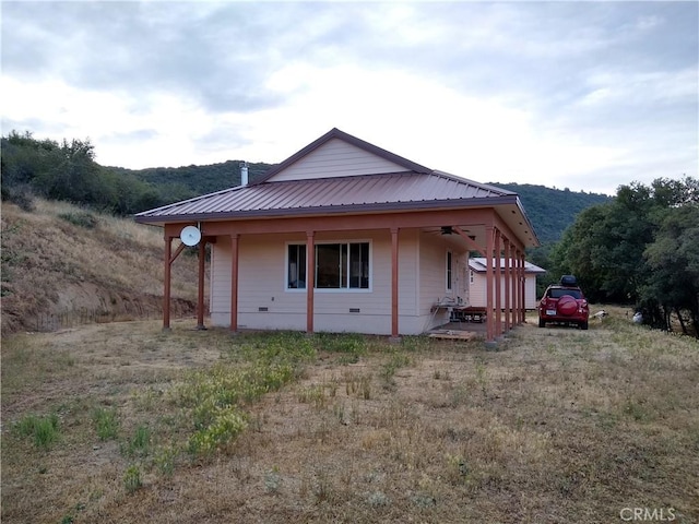 view of side of home featuring ceiling fan