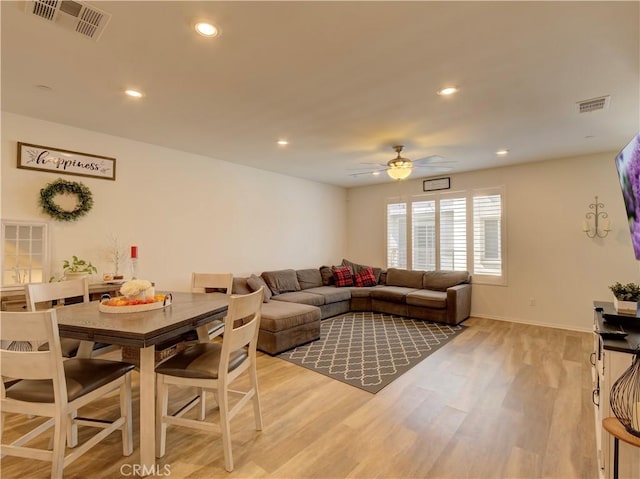 living room with ceiling fan and light hardwood / wood-style floors