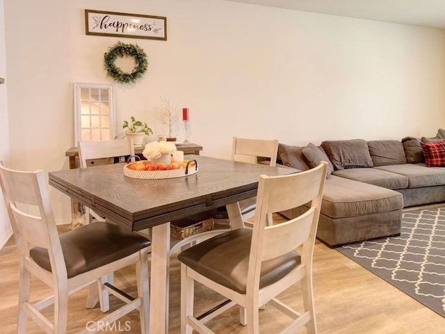 dining space featuring light wood-type flooring