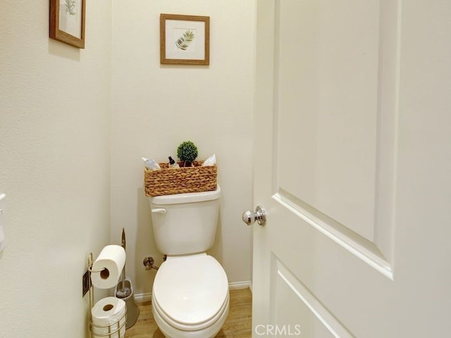 bathroom with wood-type flooring and toilet