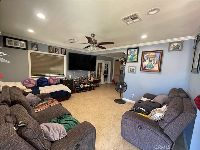 living room with ceiling fan and ornamental molding