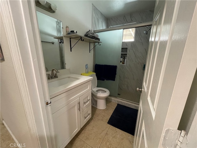 bathroom featuring walk in shower, vanity, toilet, and tile patterned floors