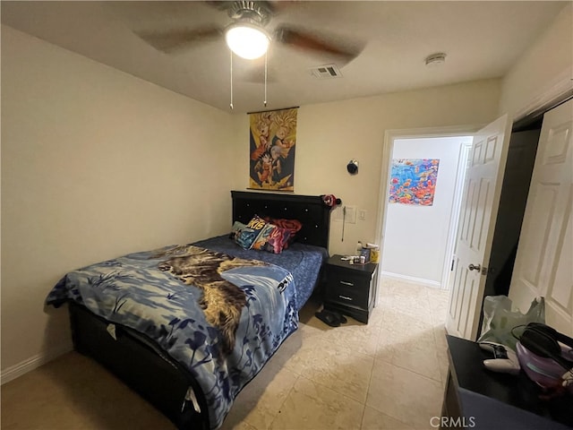 tiled bedroom featuring ceiling fan