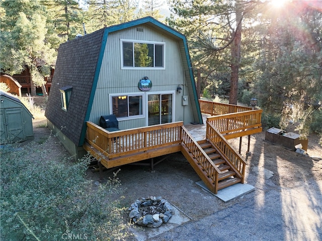 exterior space with a wooden deck and a storage unit