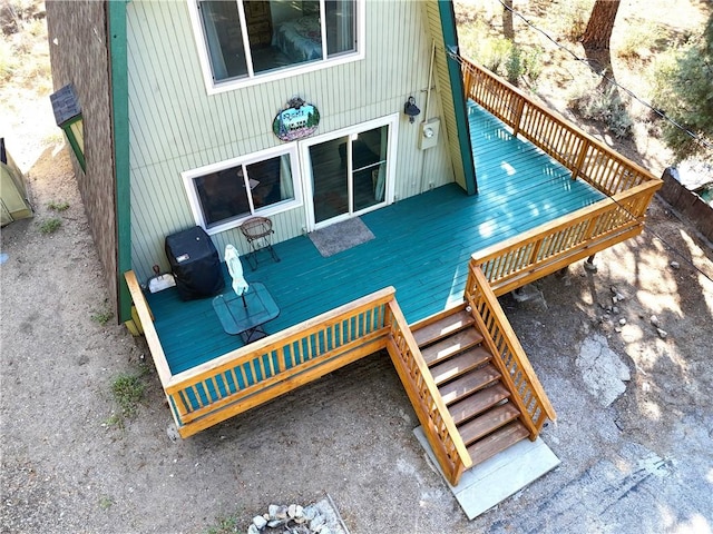 wooden terrace with stairway and a grill